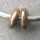 two gold beads on silver bead bangle
