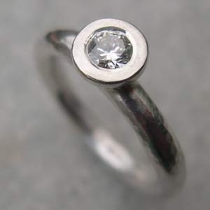 diamond ring set in silver on a silver ring