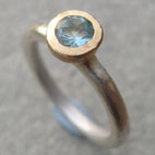 silver engagement ring with topaz set in a gold top
