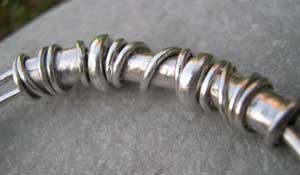 handmade silver beads on an expanding bangle