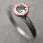 silver engagement ring with topaz set in red gold