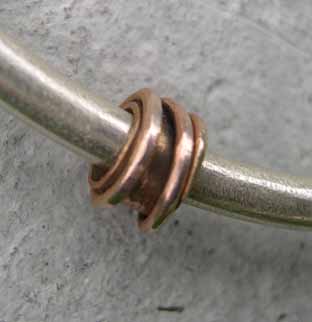 gold charm on silver bangle