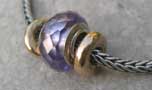 Two gold beads and an Amethyst Bead