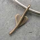 gold heart charm on silver bangle