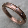 red gold eternity ring inlaid with 14 diamonds