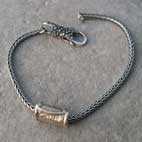 one silver bead on a silver bracelet