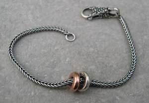 Rose gold and silver beads on a bracelet